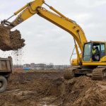экскаватор Komatsu грузит ковш грунтом на объекте
